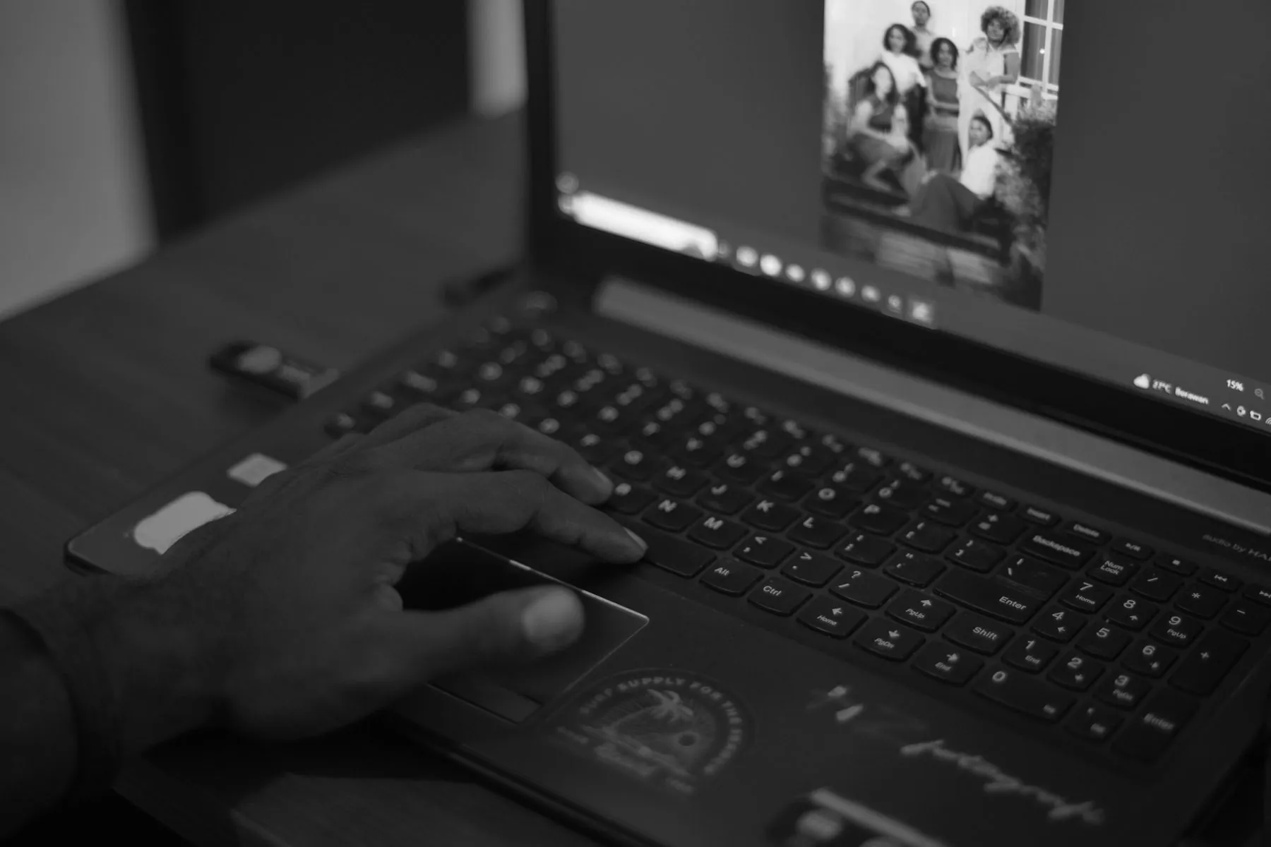 A person using a laptop computer on a desk
