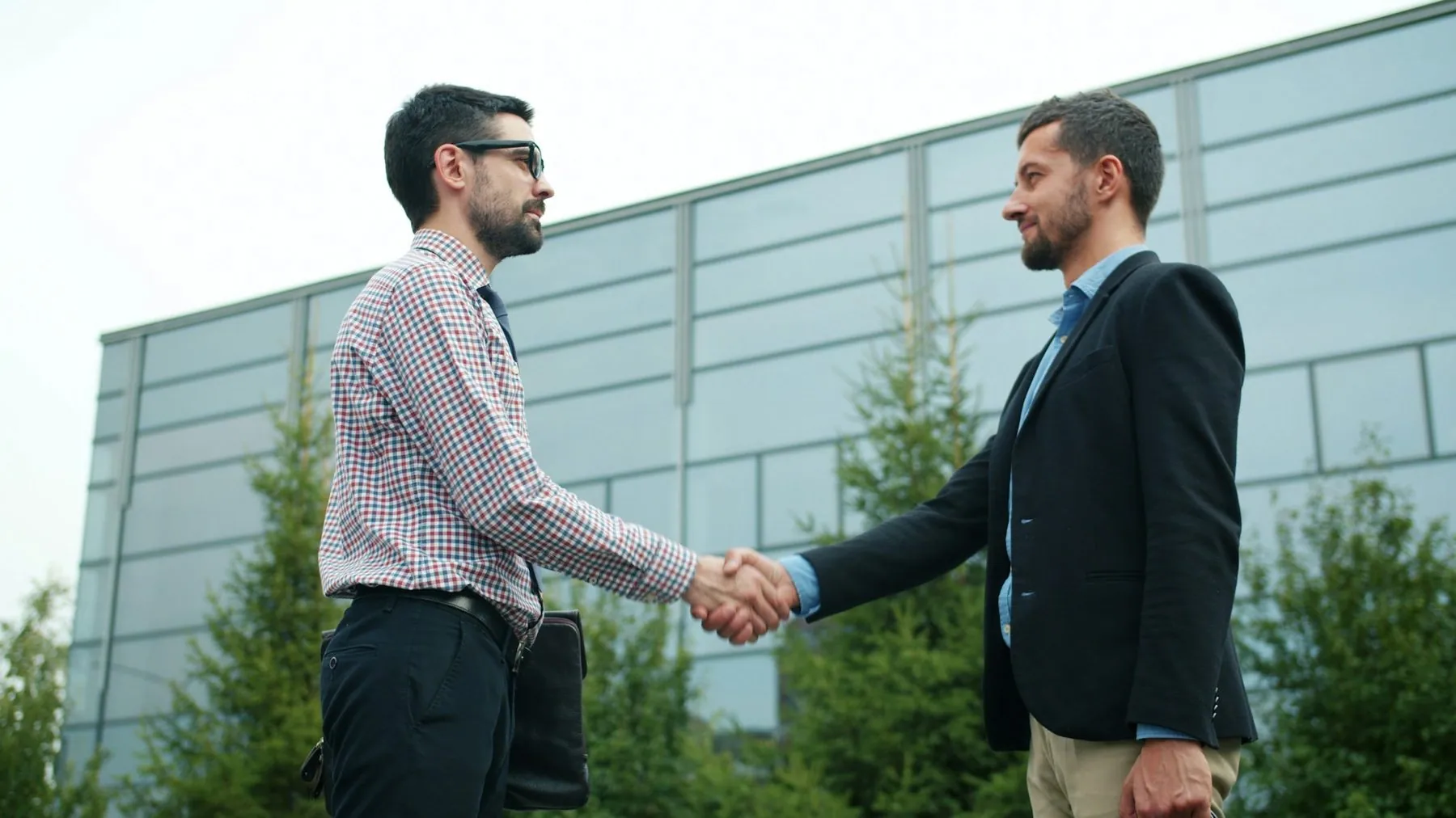 🎬 FULL 4K VIDEO for this still is in my bio link! ⬇️ Business partners smiling men are shaking hands making deal standin