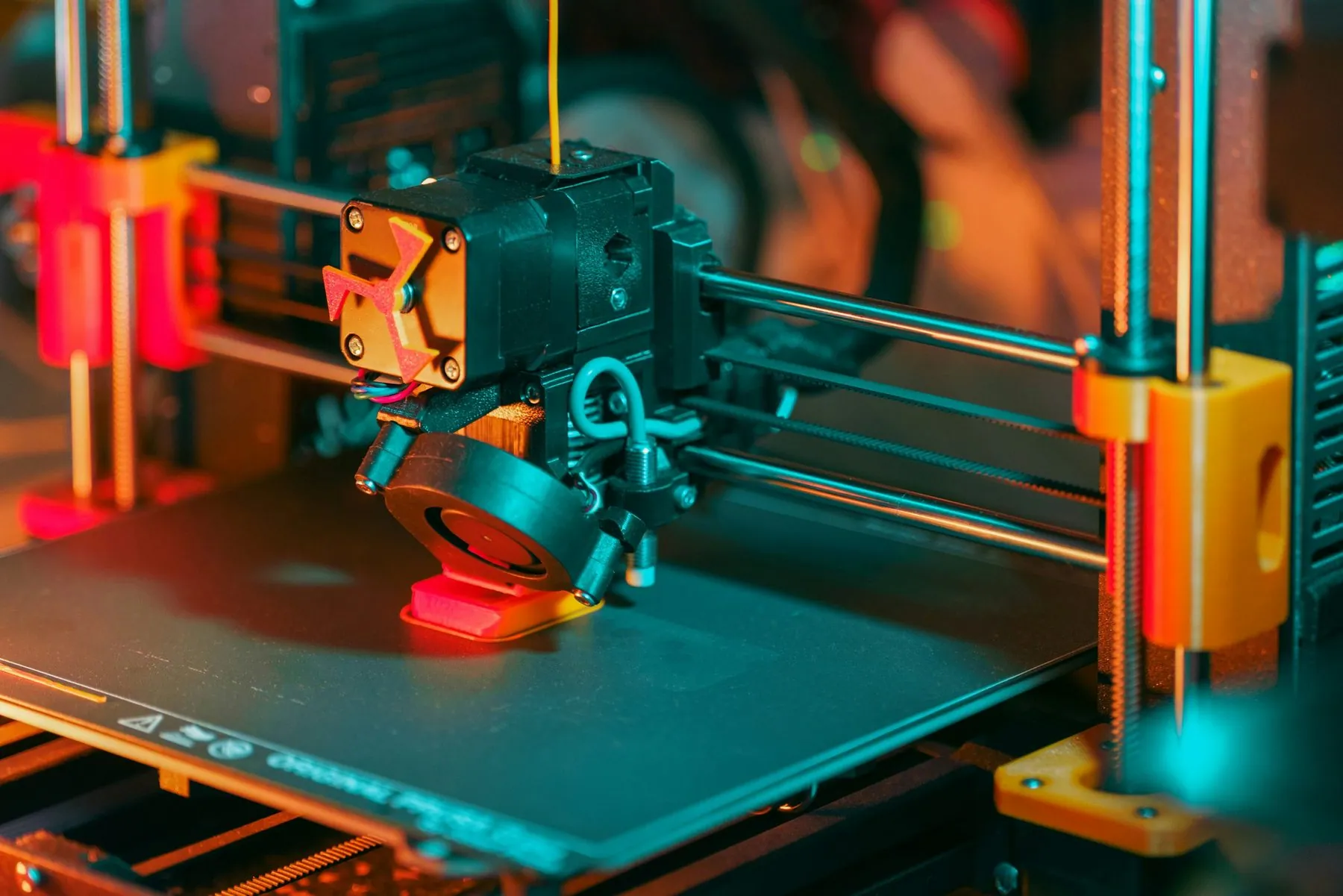 3D printer printing object modern prototyping process with visible extruder, moving axis and plastic filament deposition