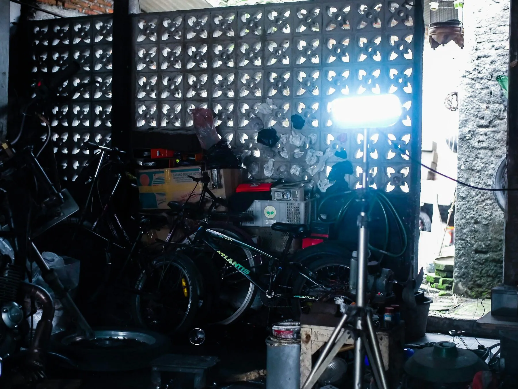 Bicycles and equipment in a cluttered workshop