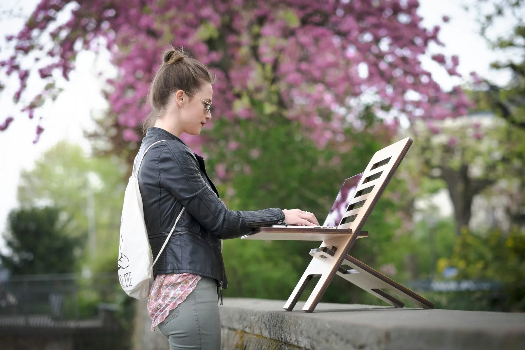 woman working outdoors on a standing desk