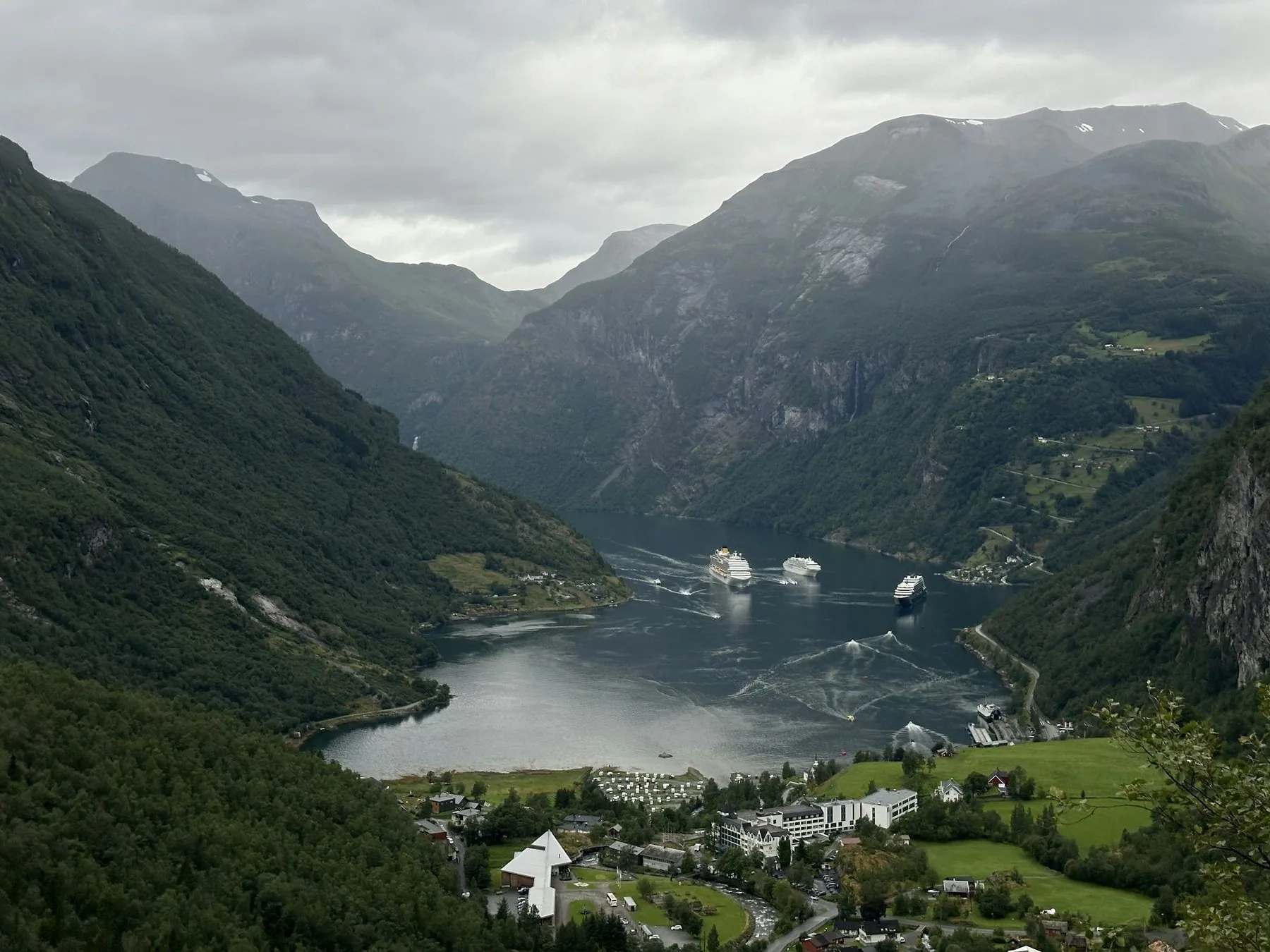 Geiranger village beside Geirangerfjord under mighty mountains, Møre og Romsdal, Norway, August 2025