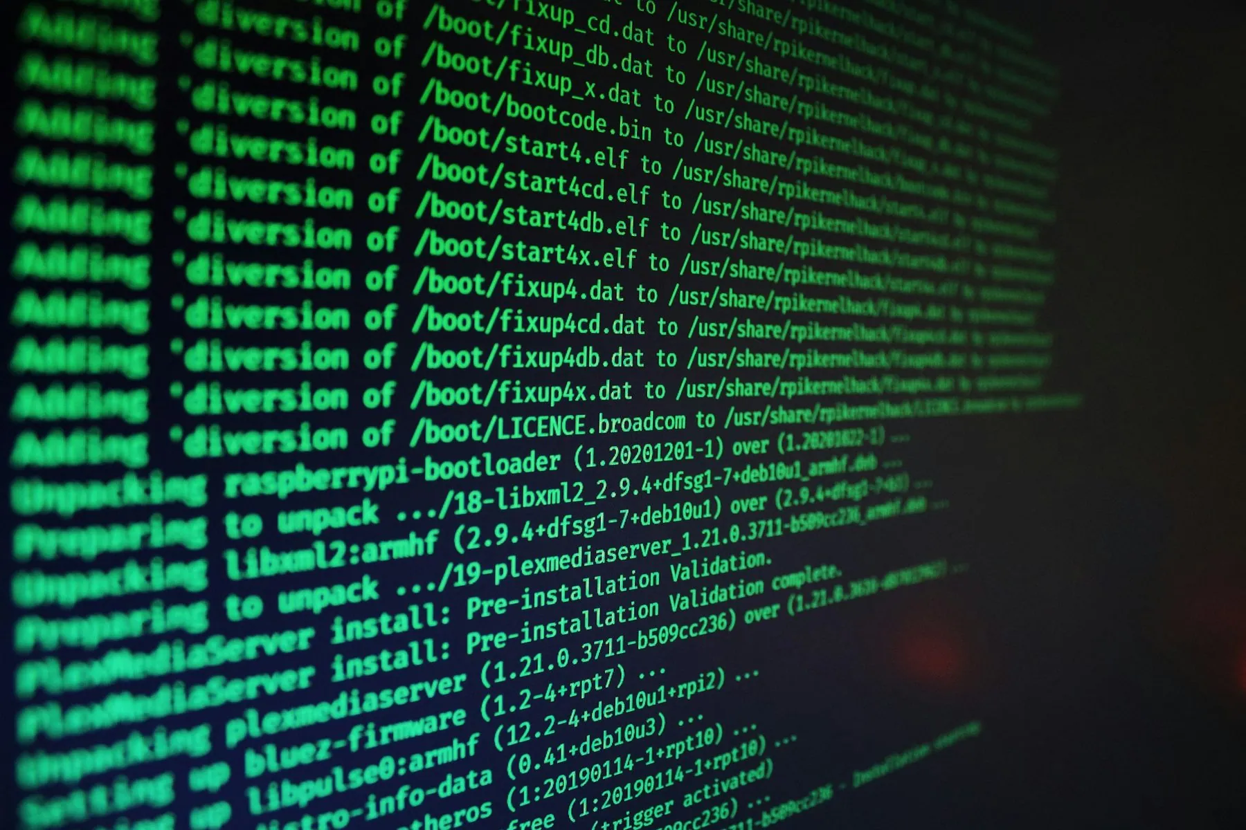 Green computer code text scrolling on a dark screen during a software installation