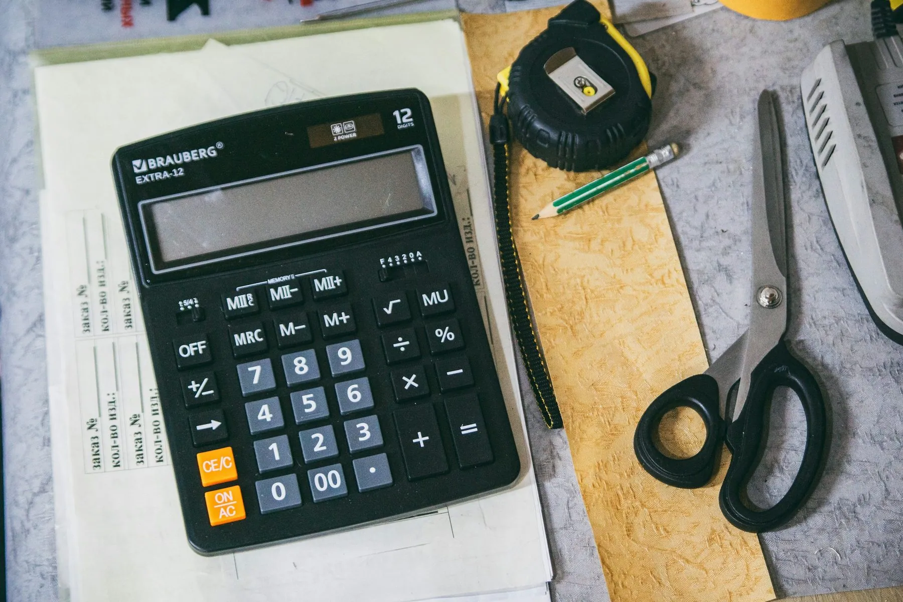 Calculator and office supplies on a desk
