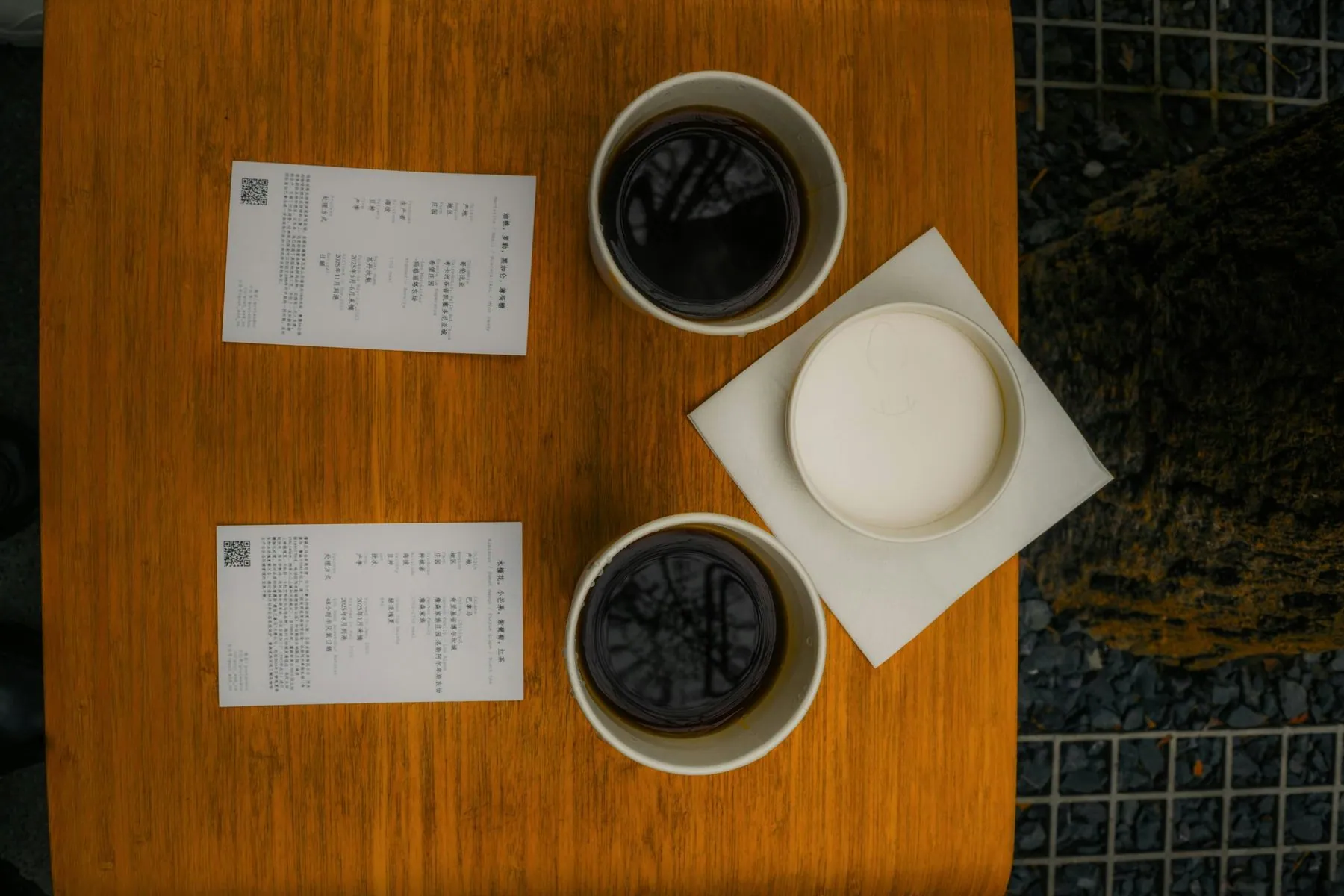 Two cups of coffee with papers on wooden table