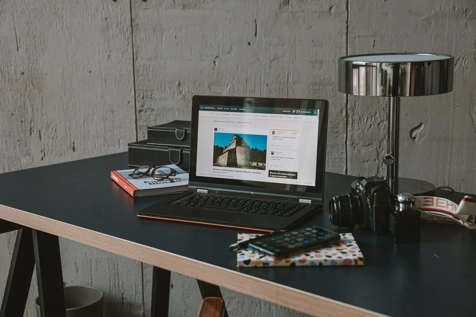 a laptop computer sitting on top of a wooden desk