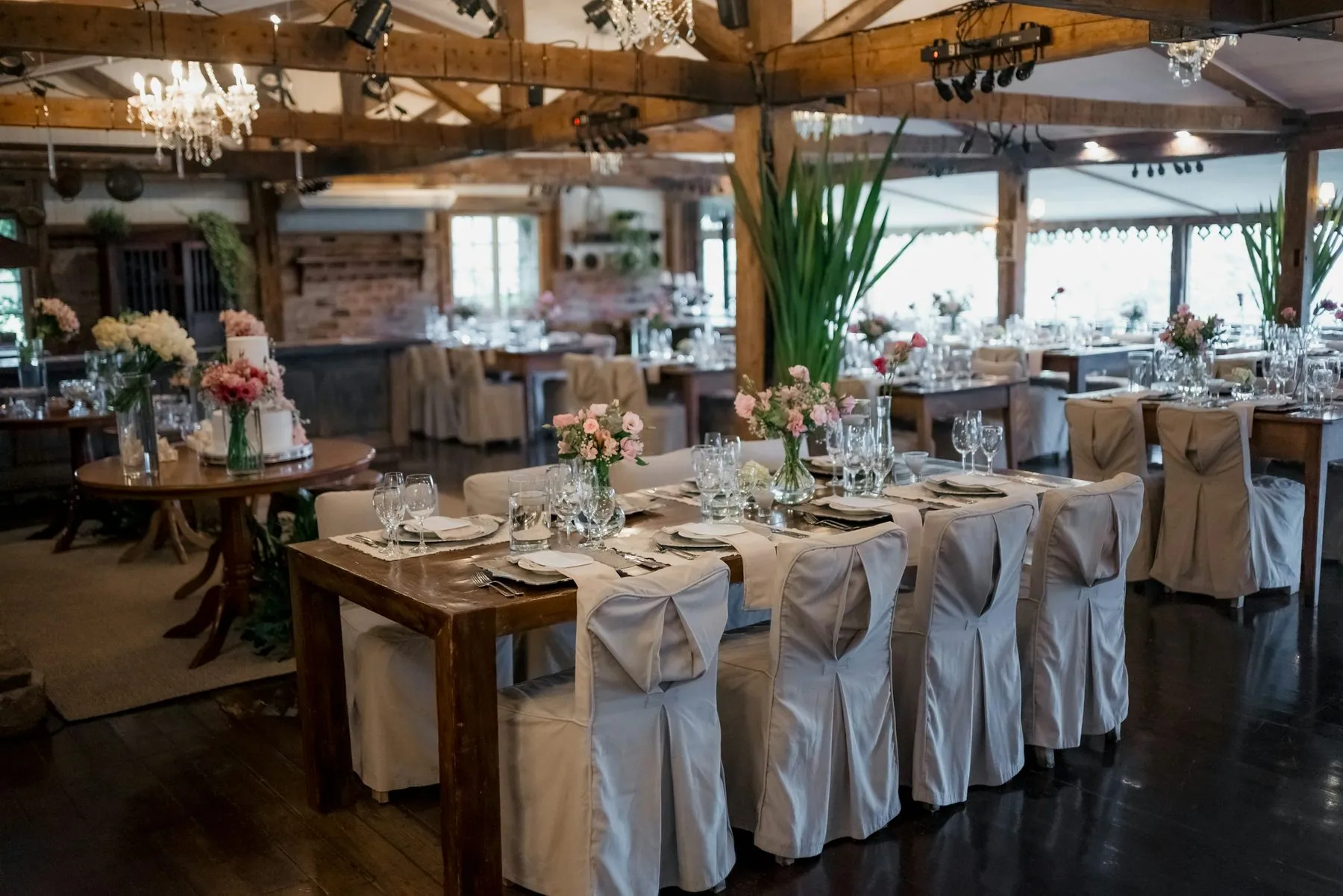 Wedding reception hall with decorated tables and chandeliers